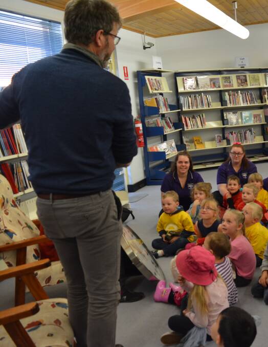 Simultaneous Storytime regular reader James Hooke entertains the children with his unique retelling of the story at Gloucester Library. Photo Anne Keen